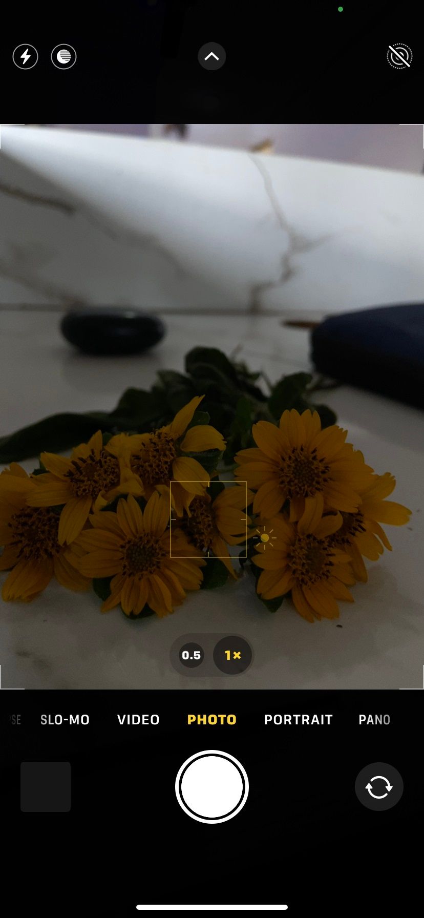 Экран смартфона с пониженным ползунком экспозиции; ползунок обозначен и показан вниз