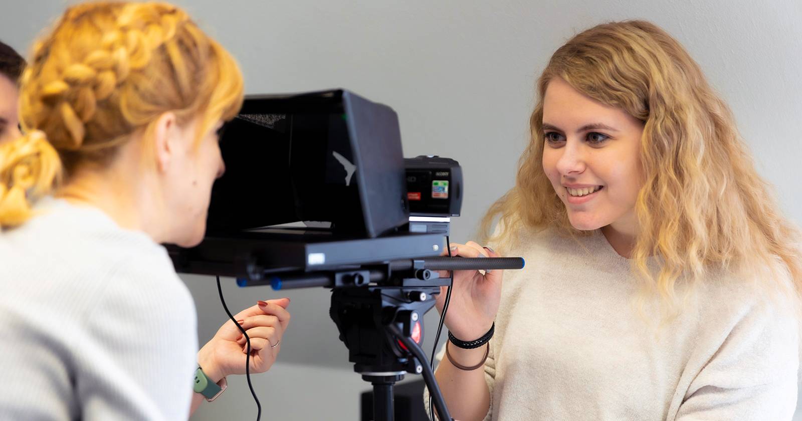 two people working with a teleprompter