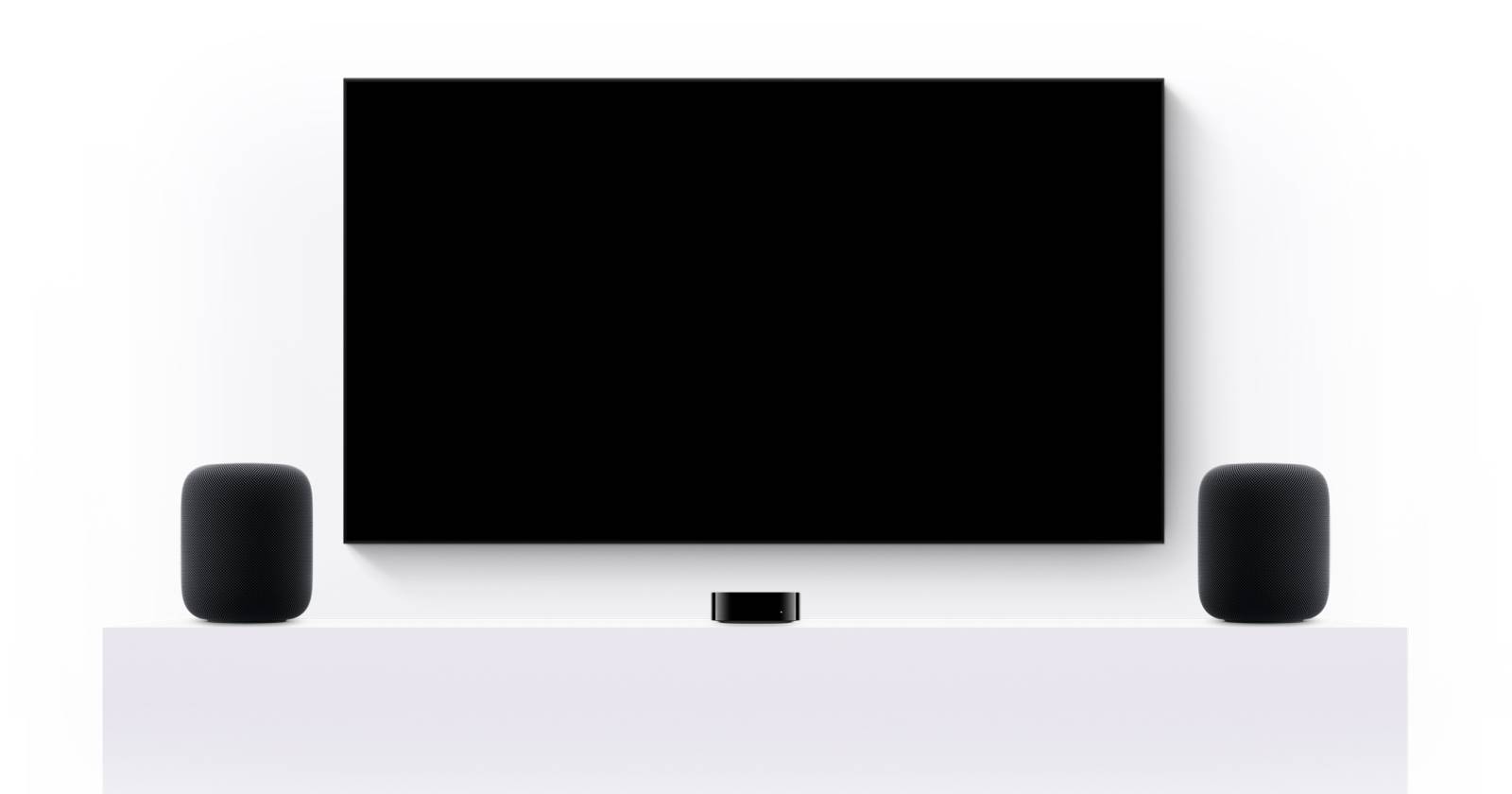 Два HomePod рядом с Apple TV на столе, иллюстрация конфигурации стереопары