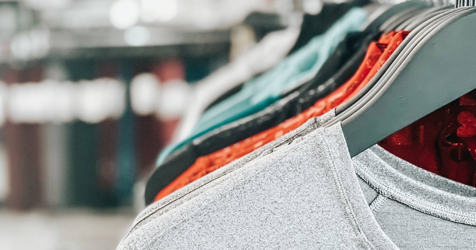 Ряд футболок на вешалках