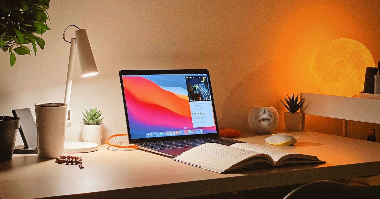 Ноутбук MacBook и книга на столе