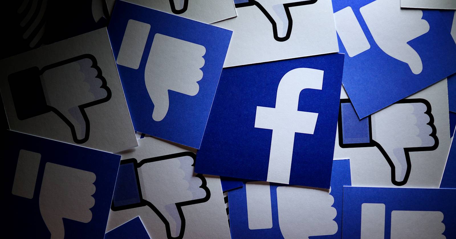 facebook logo with dislike thumbs surrounding