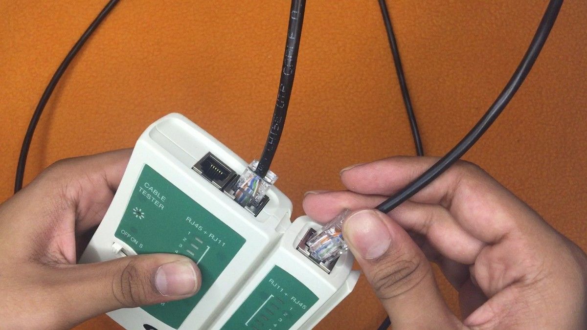 Ethernet cable being connected to an Ethernet cable tester