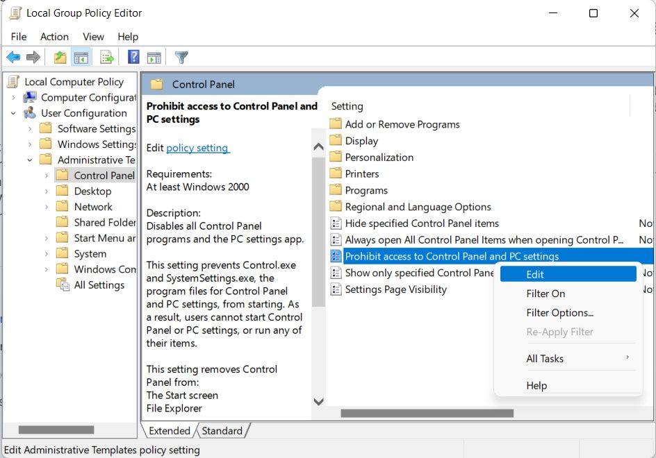 Выбор параметра для редактирования групповой политики, отключающей «Параметры» и «Панель управления» в Windows 11