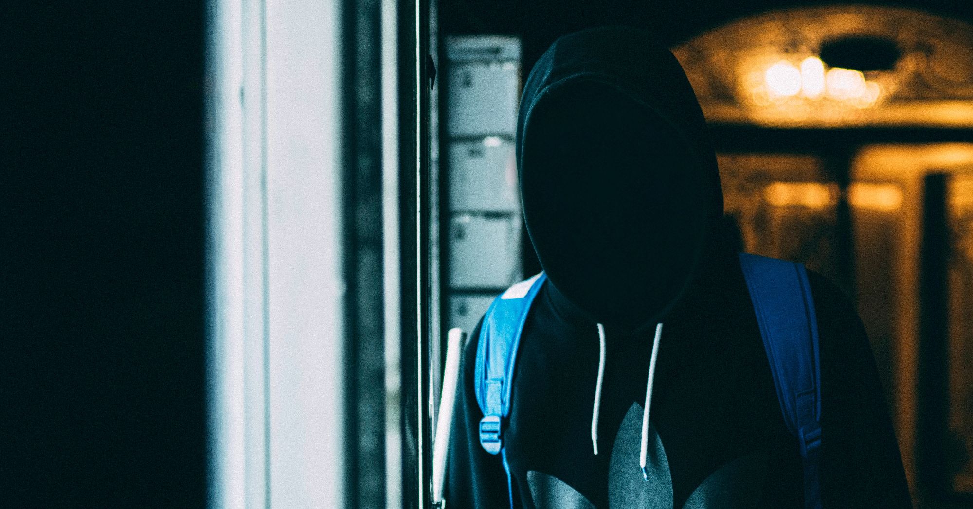 anonymous person wearing black hoodie looking at camera