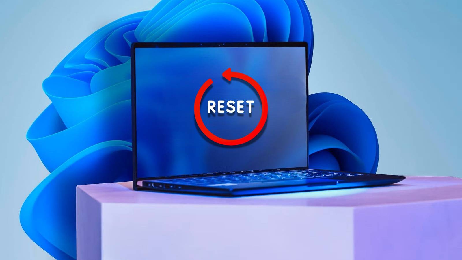 Ноутбук с наклейкой Reset на экране и обоями Windows 11 на фоне