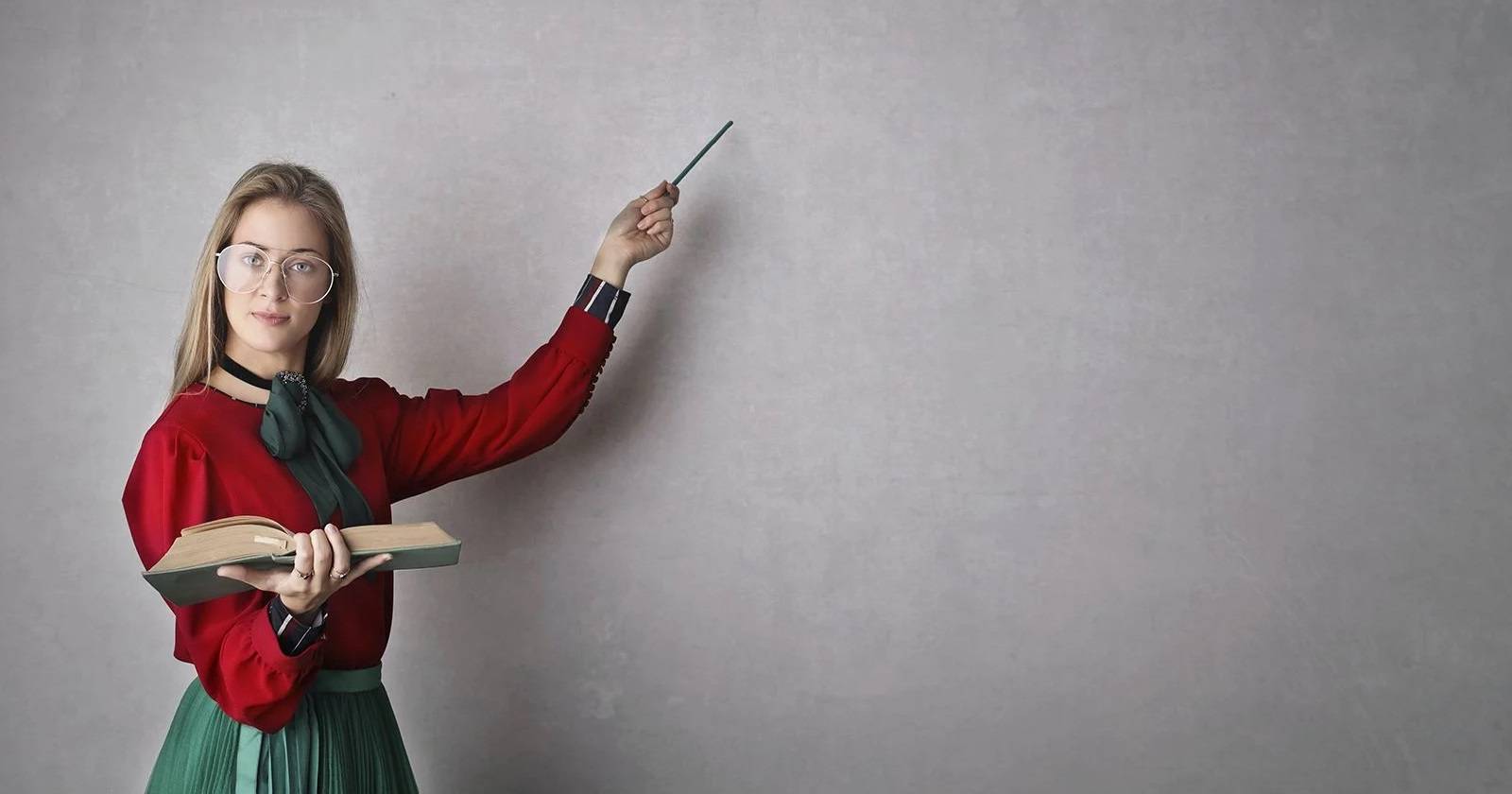 teacher-pointing-at-white-wall