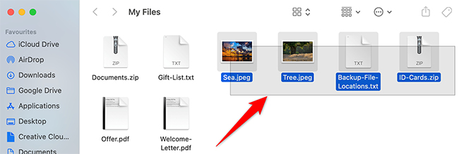 Drag with a mouse or trackpad to select multiple files in Finder.
