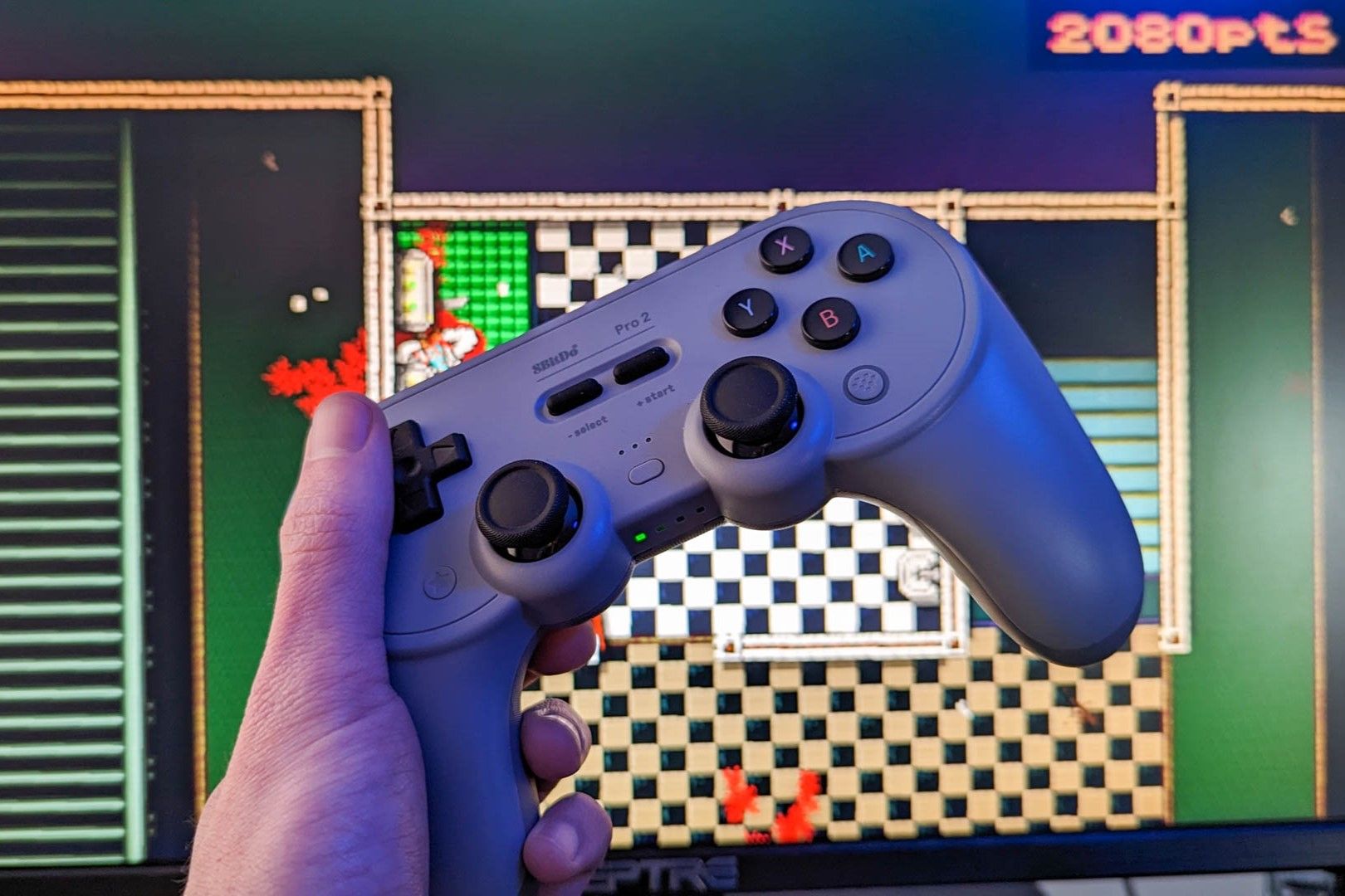 8Bitdo Pro 2 wireless controller with a computer monitor