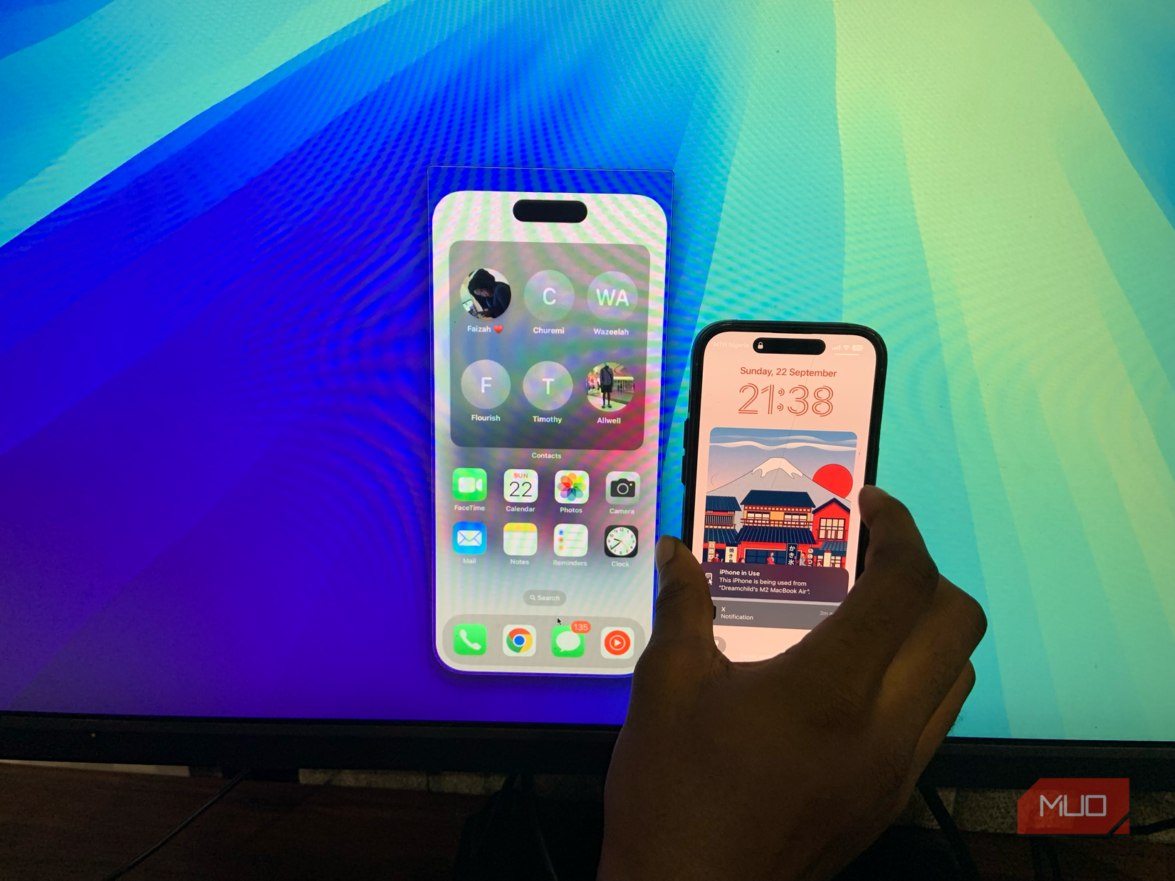 Side-by-side view of an iPhone next to an iPhone Mirroring window