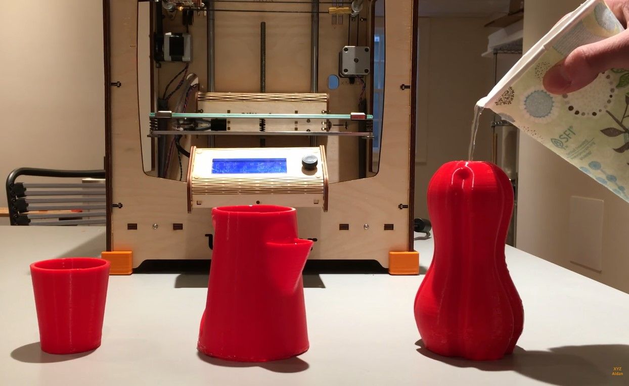 Water being poured to three designs that have been 3D printed to check if they are water tight