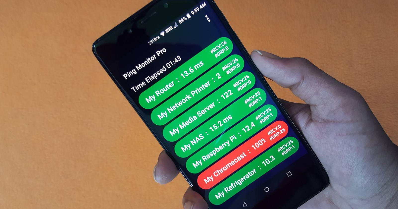 Человек с телефоном, на экране которого Ping Monitor Pro показывает статус нескольких устройств в сети
