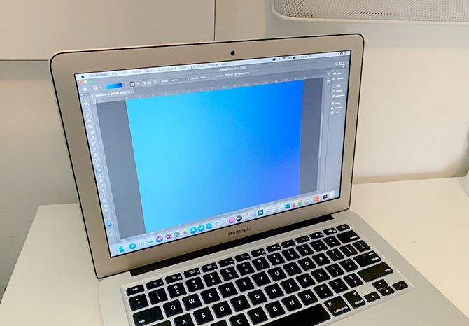 Человек работает за ноутбуком дома у окна