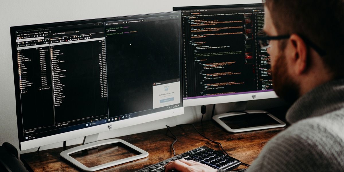 man coding on laptop